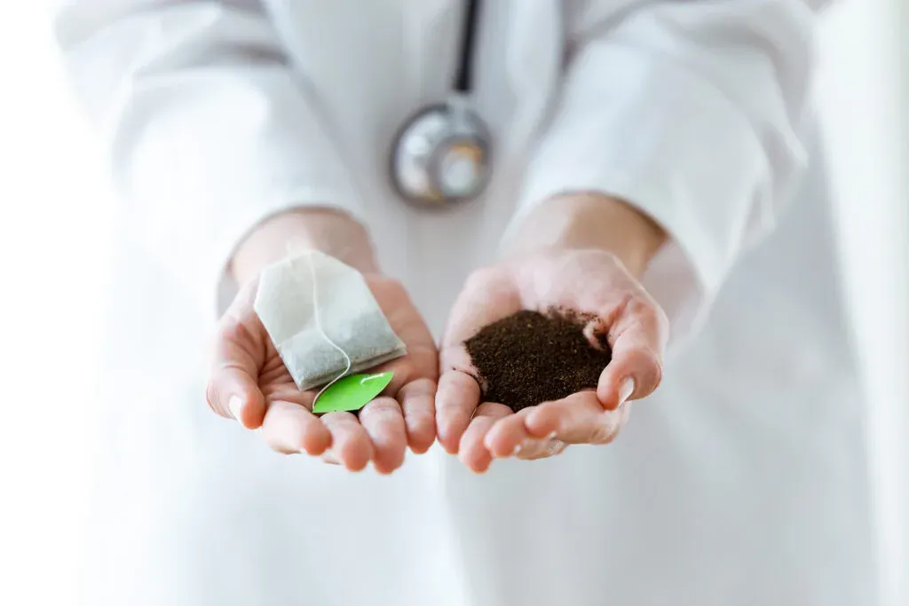 Loose leaf tea held in a doctor’s hands