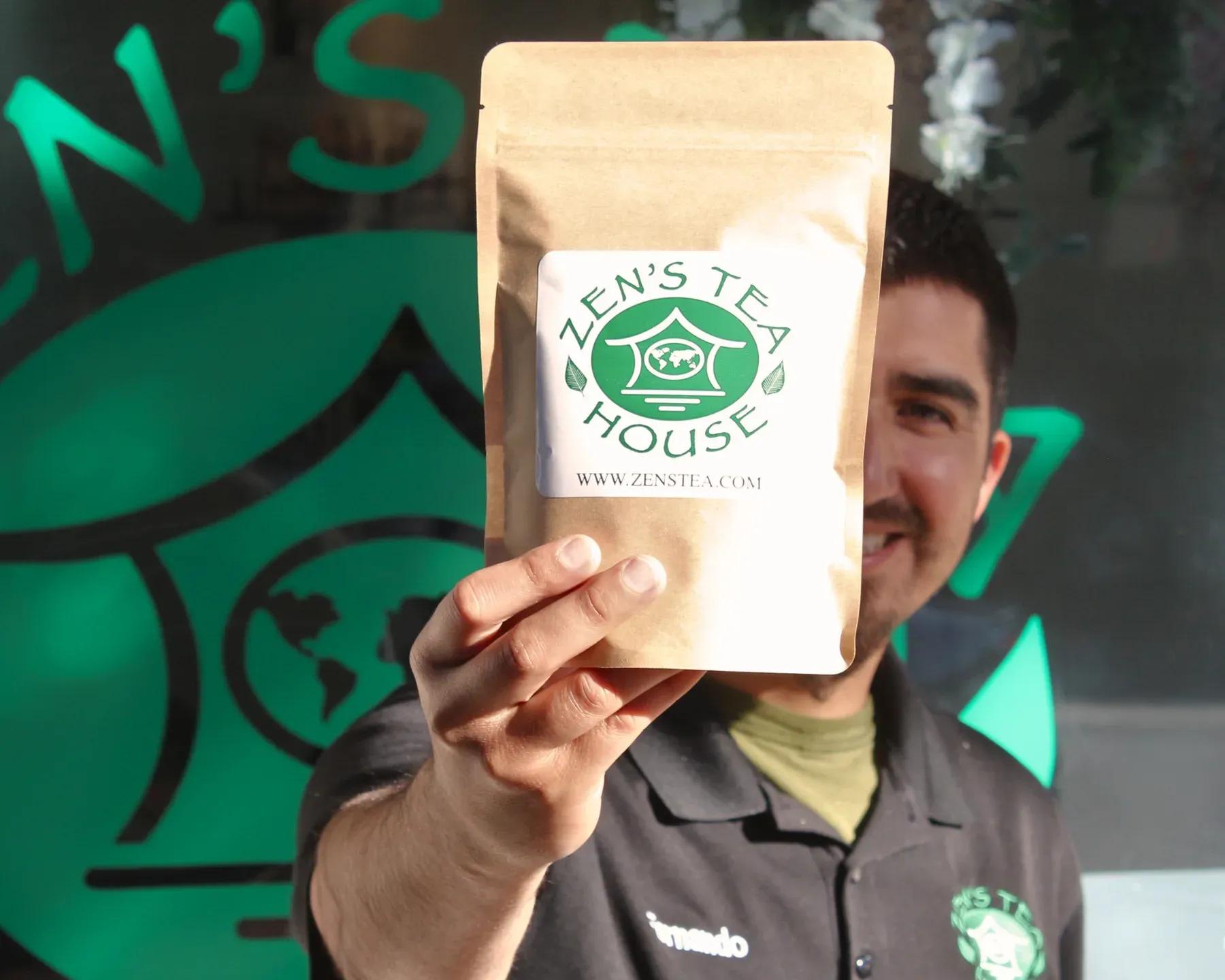 Fernando Lopez holding a bag of Zen’s Tea House tea